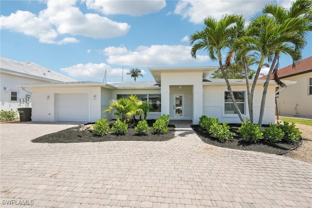 18195 Cutlass Dr, Fort Myers Beach, FL 33931 - view of front of home with decorative driveway, stucco siding, and an attached garage