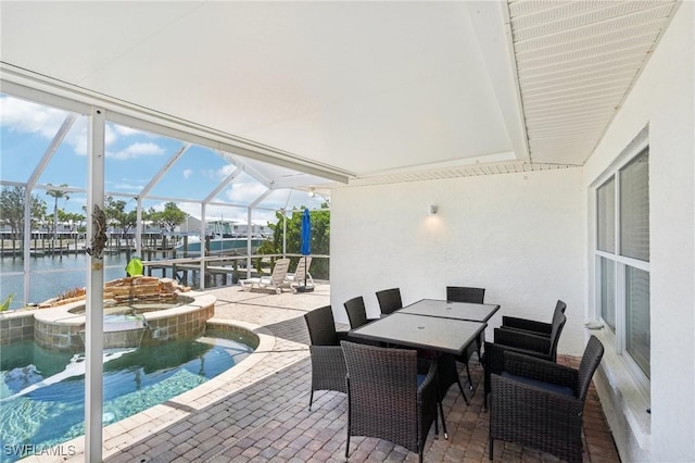 18195 Cutlass Dr, Fort Myers Beach, FL 33931 - view of patio with a water view, a lanai, a pool with connected hot tub, and outdoor dining area
