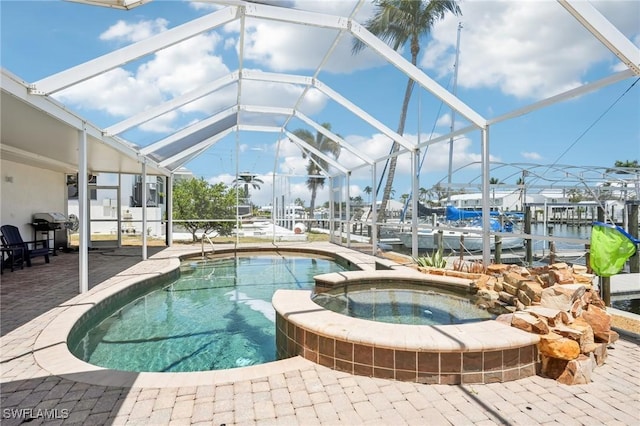 18195 Cutlass Dr, Fort Myers Beach, FL 33931 - view of pool featuring a patio, a pool with connected hot tub, glass enclosure, a boat dock, and boat lift