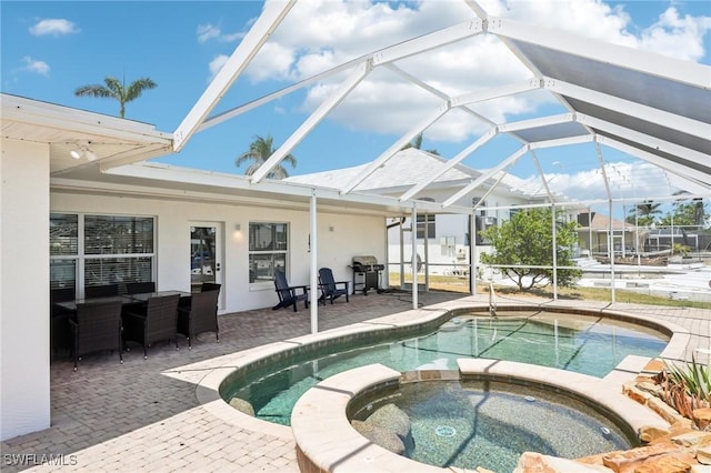 18195 Cutlass Dr, Fort Myers Beach, FL 33931 - view of pool with a patio area, a pool with connected hot tub, area for grilling, and glass enclosure