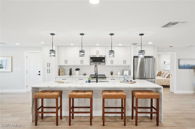18195 Cutlass Dr, Fort Myers Beach, FL 33931 - kitchen with appliances with stainless steel finishes, recessed lighting, baseboards, white cabinetry, and light stone counters