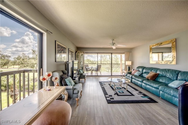 6979 Winkler Rd Unit 131, Fort Myers, FL 33919 - living room with a textured ceiling, wood finished floors, and ceiling fan