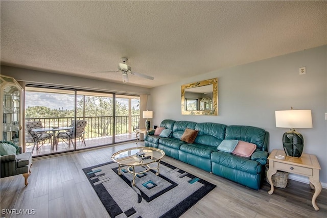 6979 Winkler Rd Unit 131, Fort Myers, FL 33919 - living room with a textured ceiling, a ceiling fan, and wood finished floors