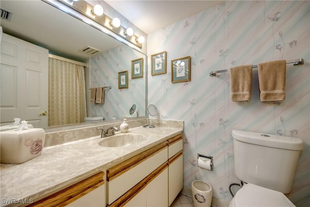 6979 Winkler Rd Unit 131, Fort Myers, FL 33919 - bathroom featuring toilet, vanity, wallpapered walls, and curtained shower