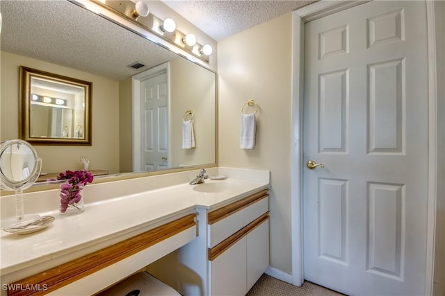 6979 Winkler Rd Unit 131, Fort Myers, FL 33919 - bathroom with a textured ceiling and vanity