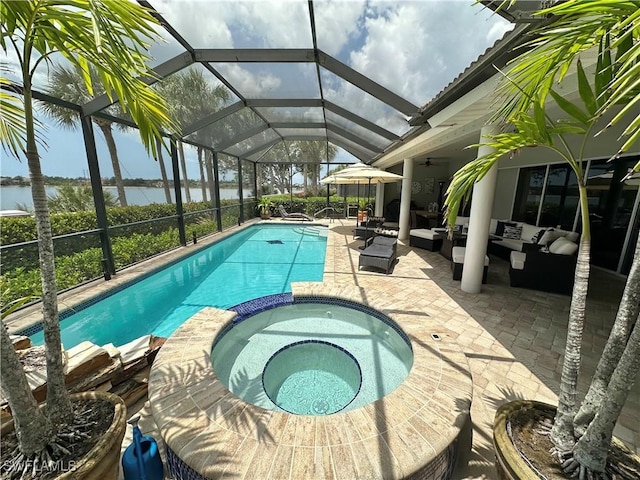 5593 Whispering Willow Way, Fort Myers, FL 33908 - view of pool with an outdoor hangout area, a patio area, a pool with connected hot tub, a ceiling fan, and a water view