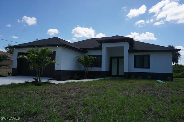 826 Alido Ave, Lehigh Acres, FL 33971 - view of front facade with french doors, driveway, an attached garage, and stucco siding