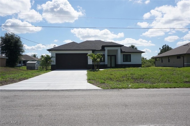 826 Alido Ave, Lehigh Acres, FL 33971 - prairie-style home with concrete driveway, a garage, a front yard, and stucco siding
