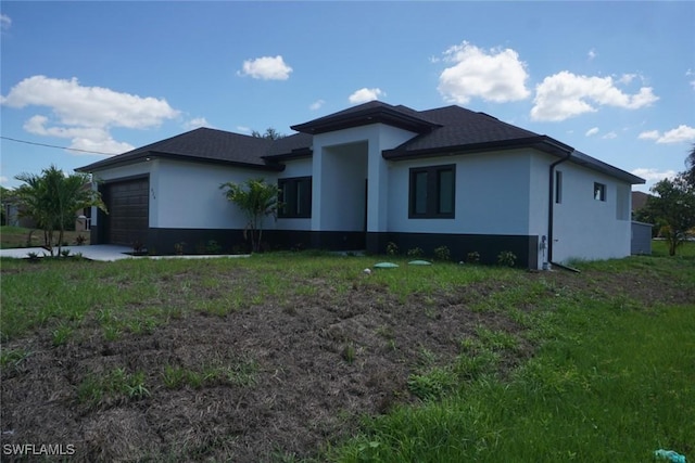 826 Alido Ave, Lehigh Acres, FL 33971 - prairie-style home with stucco siding and an attached garage