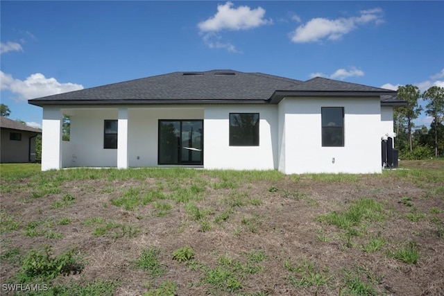 826 Alido Ave, Lehigh Acres, FL 33971 - rear view of property with stucco siding and roof with shingles