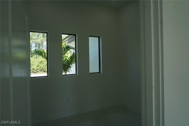 826 Alido Ave, Lehigh Acres, FL 33971 - spare room featuring marble look tile flooring and baseboards