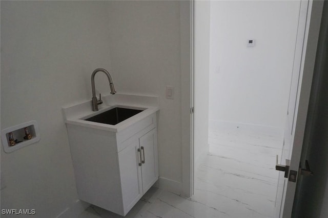 826 Alido Ave, Lehigh Acres, FL 33971 - laundry area featuring light marble finish flooring, hookup for a washing machine, and baseboards