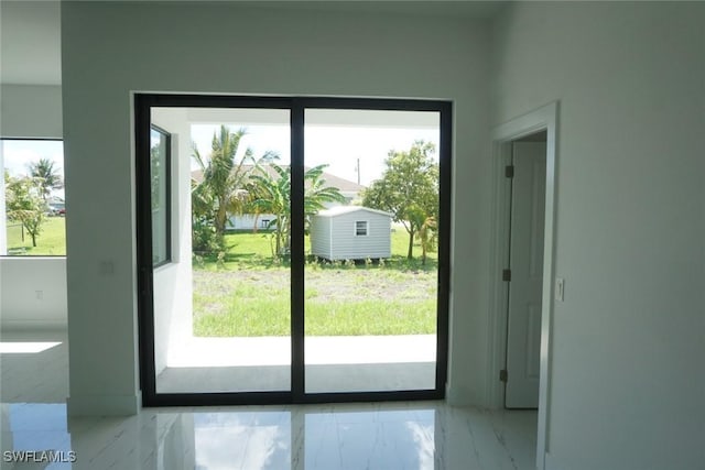 826 Alido Ave, Lehigh Acres, FL 33971 - doorway with healthy amount of natural light and marble finish flooring