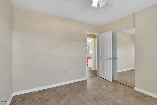 250 Bangsberg Rd SE, Port Charlotte, FL 33952 - unfurnished bedroom with baseboards, a closet, ceiling fan, and tile patterned flooring