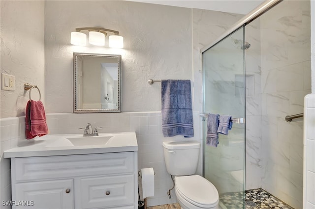 250 Bangsberg Rd SE, Port Charlotte, FL 33952 - bathroom featuring a marble finish shower, vanity, tile walls, toilet, and wainscoting