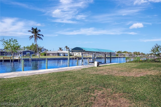250 Bangsberg Rd SE, Port Charlotte, FL 33952 - dock area featuring a water view, a lawn, boat lift, and a residential view
