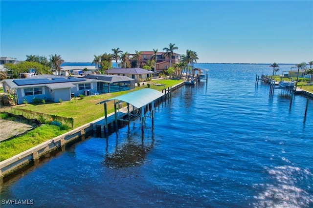 250 Bangsberg Rd SE, Port Charlotte, FL 33952 - dock area featuring a water view and a lawn