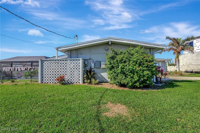 250 Bangsberg Rd SE, Port Charlotte, FL 33952 - view of side of home with a yard