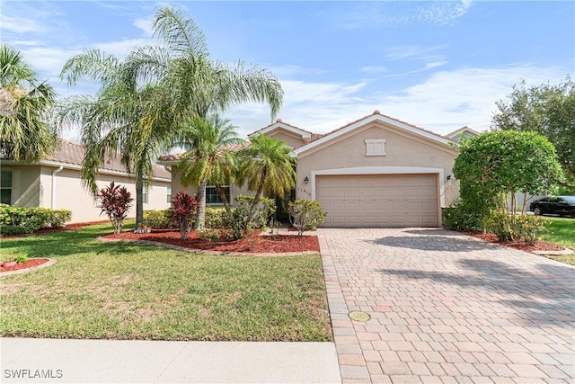 11430 Icarus Cir, Lehigh Acres, FL 33971 - view of front of home with stucco siding, an attached garage, a front lawn, and decorative driveway