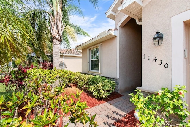 11430 Icarus Cir, Lehigh Acres, FL 33971 - view of exterior entry featuring stucco siding