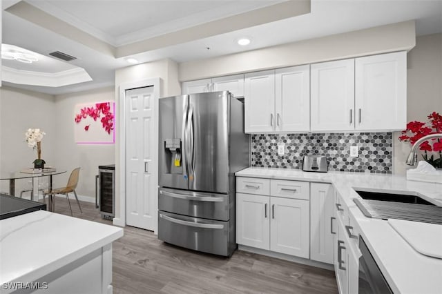 1793 Four Mile Cove Pkwy Unit 723, Cape Coral, FL 33990 - kitchen with stainless steel fridge with ice dispenser, crown molding, tasteful backsplash, a sink, and a raised ceiling