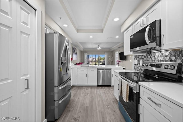 1793 Four Mile Cove Pkwy Unit 723, Cape Coral, FL 33990 - kitchen with stainless steel appliances, a raised ceiling, crown molding, recessed lighting, and light wood-style floors