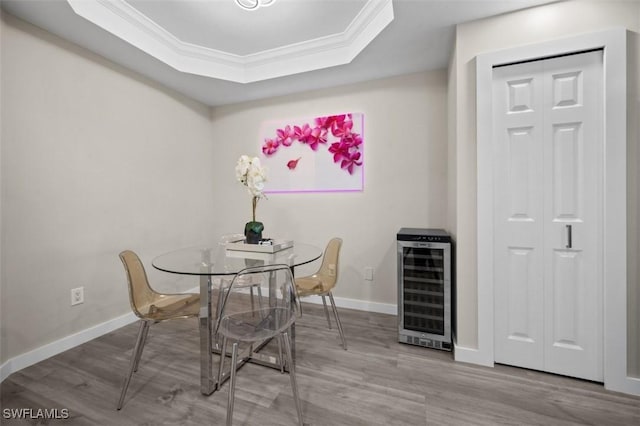 1793 Four Mile Cove Pkwy Unit 723, Cape Coral, FL 33990 - dining room with beverage cooler, wood finished floors, ornamental molding, a raised ceiling, and baseboards