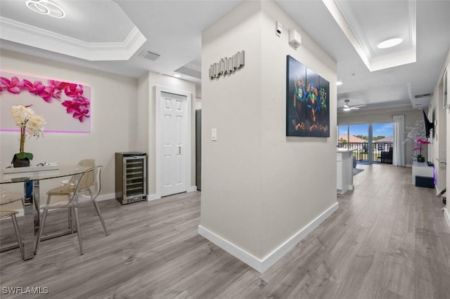 1793 Four Mile Cove Pkwy Unit 723, Cape Coral, FL 33990 - hall featuring beverage cooler, a raised ceiling, wood finished floors, baseboards, and crown molding