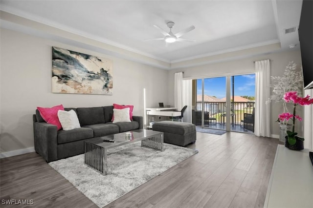 1793 Four Mile Cove Pkwy Unit 723, Cape Coral, FL 33990 - living room with a raised ceiling, ceiling fan, wood finished floors, and crown molding