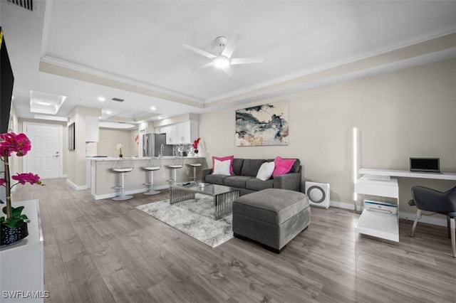 1793 Four Mile Cove Pkwy Unit 723, Cape Coral, FL 33990 - living room with a tray ceiling, crown molding, wood finished floors, ceiling fan, and baseboards