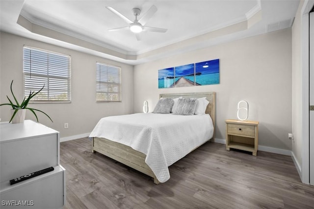 1793 Four Mile Cove Pkwy Unit 723, Cape Coral, FL 33990 - bedroom featuring a raised ceiling, ornamental molding, wood finished floors, baseboards, and ceiling fan