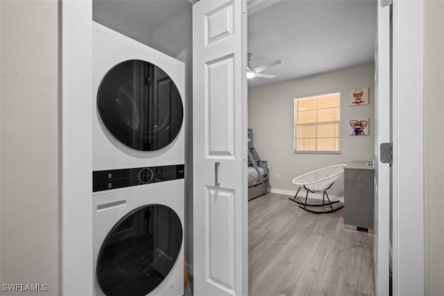 1793 Four Mile Cove Pkwy Unit 723, Cape Coral, FL 33990 - laundry room with stacked washer / drying machine, light wood-type flooring, ceiling fan, and baseboards