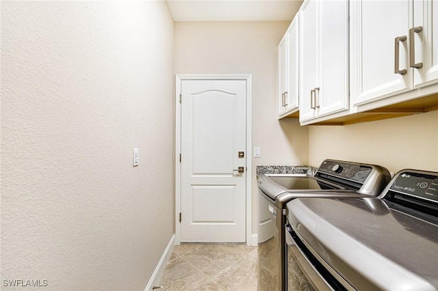19197 Elston Way, Estero, FL 33928 - laundry room with cabinet space, separate washer and dryer, baseboards, and light tile patterned floors