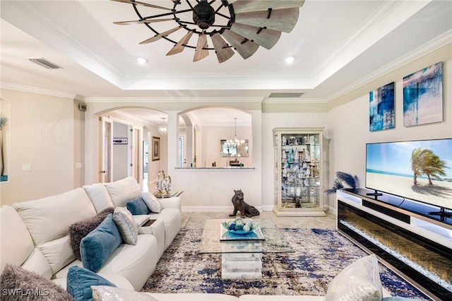 19197 Elston Way, Estero, FL 33928 - living area with a raised ceiling, arched walkways, crown molding, baseboards, and a chandelier