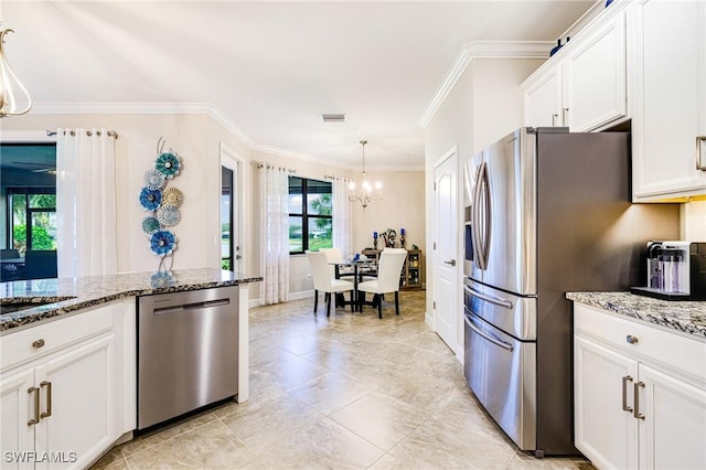 19197 Elston Way, Estero, FL 33928 - kitchen with appliances with stainless steel finishes, a chandelier, ornamental molding, stone counters, and white cabinets