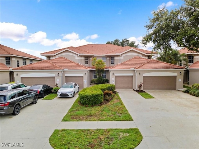2005 Crestview Way Unit 18B, Naples, FL 34119 - mediterranean / spanish-style home featuring driveway, a tiled roof, stucco siding, and an attached garage