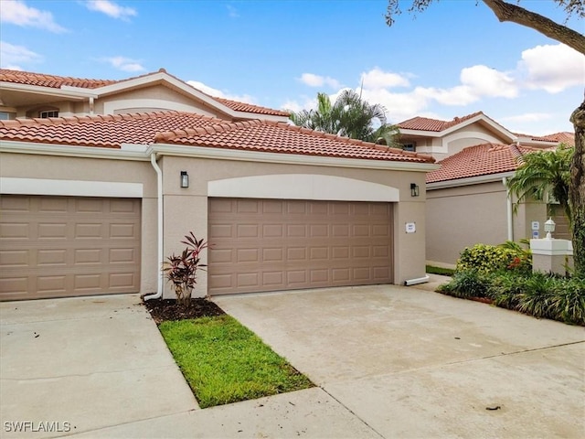 2005 Crestview Way Unit 18B, Naples, FL 34119 - mediterranean / spanish-style home featuring stucco siding, driveway, and a tile roof