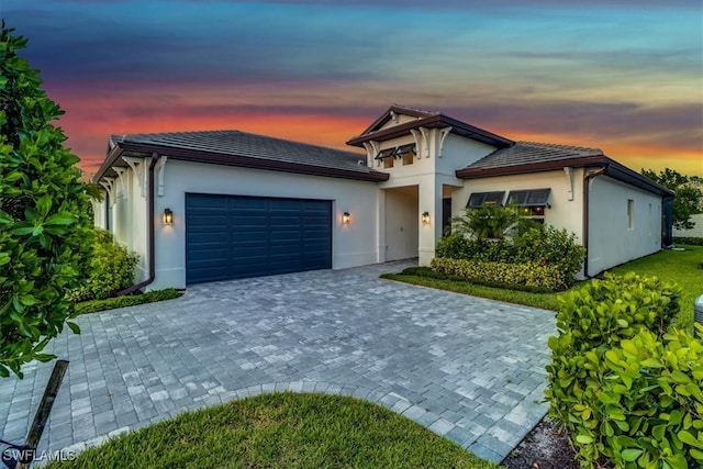 3652 Sapphire Cove Cir, Naples, FL 34114 - ranch-style house with an attached garage, decorative driveway, stucco siding, and a tiled roof