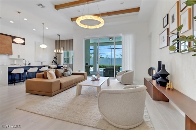 3652 Sapphire Cove Cir, Naples, FL 34114 - living area featuring light wood-style floors, recessed lighting, a chandelier, and beamed ceiling