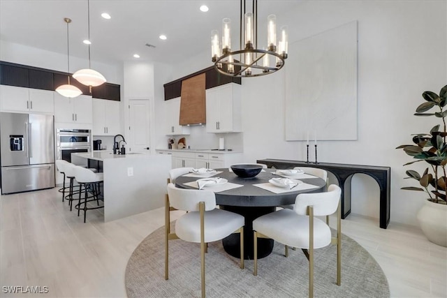3652 Sapphire Cove Cir, Naples, FL 34114 - dining room featuring a towering ceiling, a chandelier, light wood-type flooring, and recessed lighting