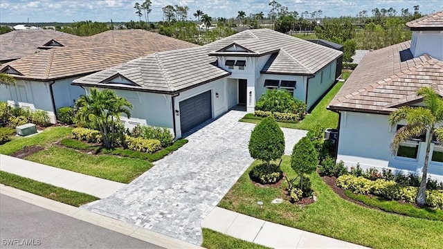 3652 Sapphire Cove Cir, Naples, FL 34114 - ranch-style house with a garage, decorative driveway, stucco siding, and a front yard