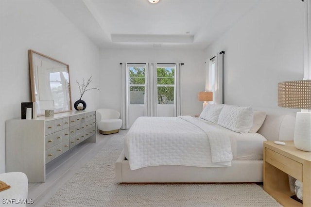 3652 Sapphire Cove Cir, Naples, FL 34114 - bedroom featuring a raised ceiling and light wood-type flooring