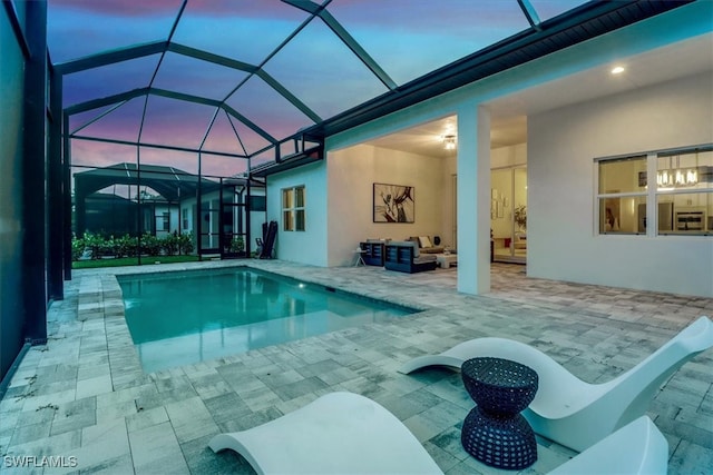 3652 Sapphire Cove Cir, Naples, FL 34114 - pool at dusk with an outdoor pool, outdoor lounge area, a patio, and glass enclosure