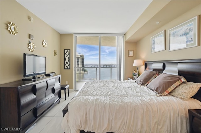 bedroom featuring access to exterior, light tile patterned flooring, and floor to ceiling windows