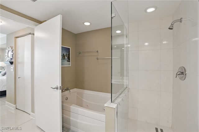 ensuite bathroom with a tile shower, a whirlpool tub, tile patterned flooring, and recessed lighting