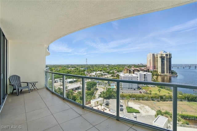 balcony featuring a water view and a view of city