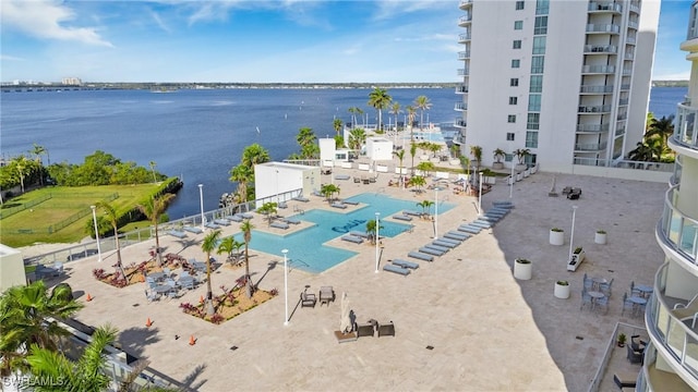 aerial view of a pool area and a large body of water