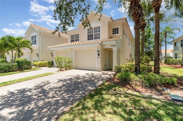 1430 Tiffany Ln Unit 2701, Naples, FL 34105 - mediterranean / spanish house featuring a tiled roof, stucco siding, driveway, and an attached garage