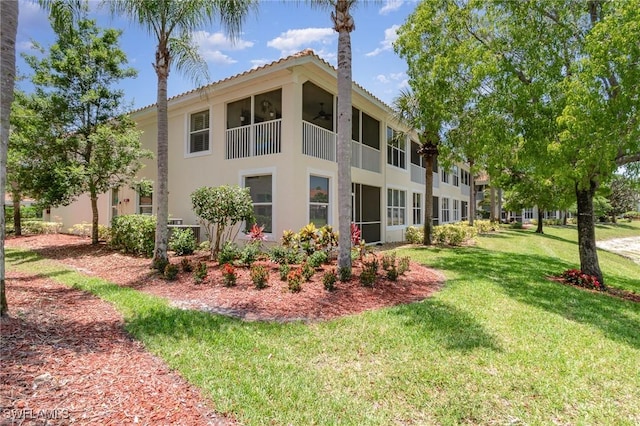 1430 Tiffany Ln Unit 2701, Naples, FL 34105 - rear view of house featuring stucco siding, a yard, and a ceiling fan