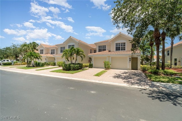 1430 Tiffany Ln Unit 2701, Naples, FL 34105 - mediterranean / spanish house with a garage, a tiled roof, stucco siding, and decorative driveway